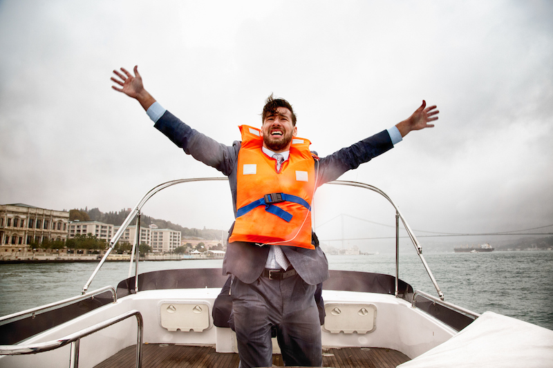 A man waves for help on a sinking ship.