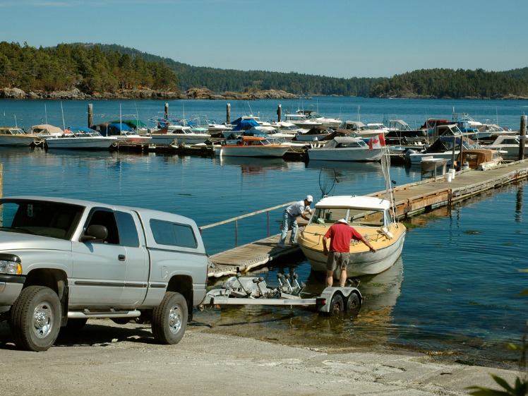 A small fishing boat being launched off a trailer